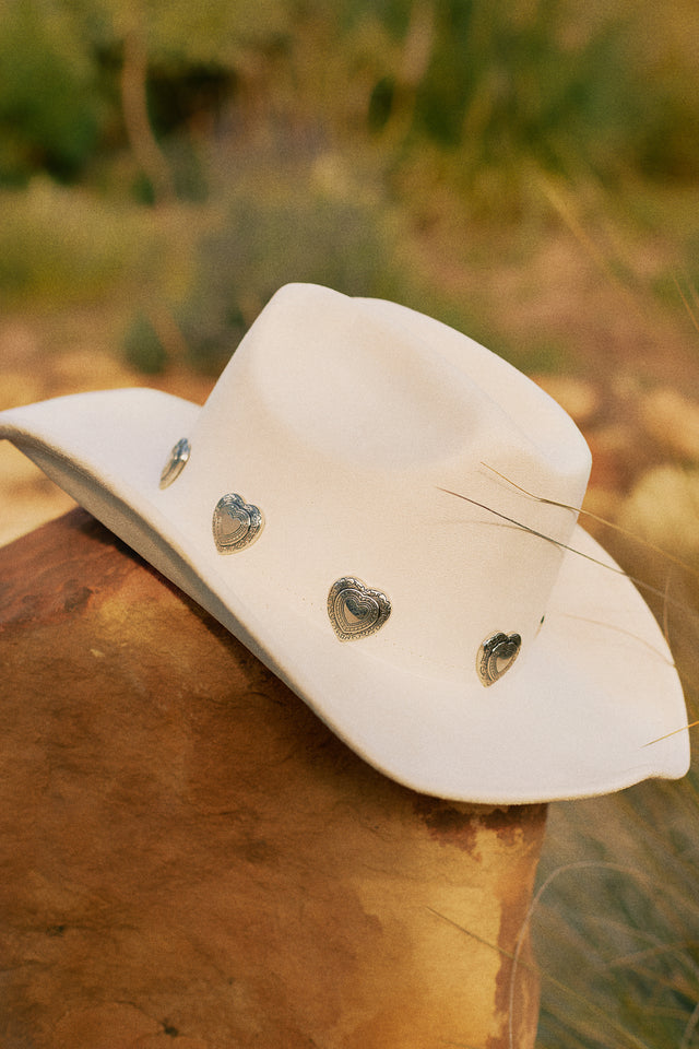 Load image into Gallery viewer, Cream Cowgirl Hat Placed On Rock
